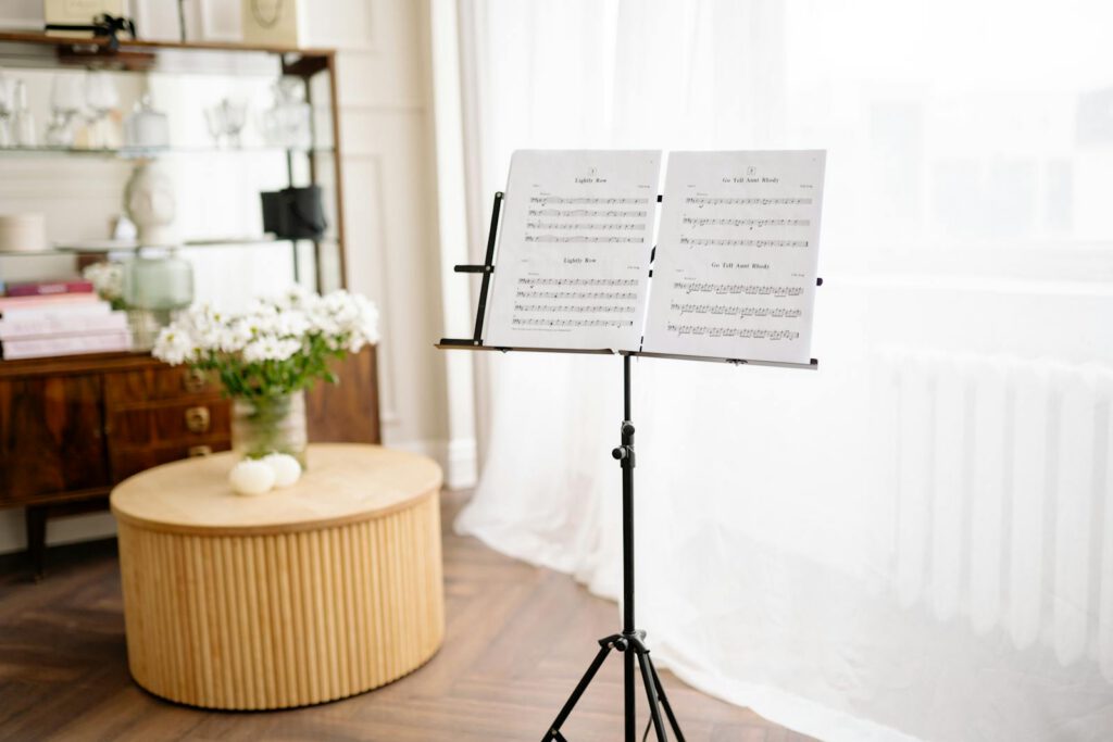 A serene home interior featuring a music stand with sheet music, surrounded by elegant decor.